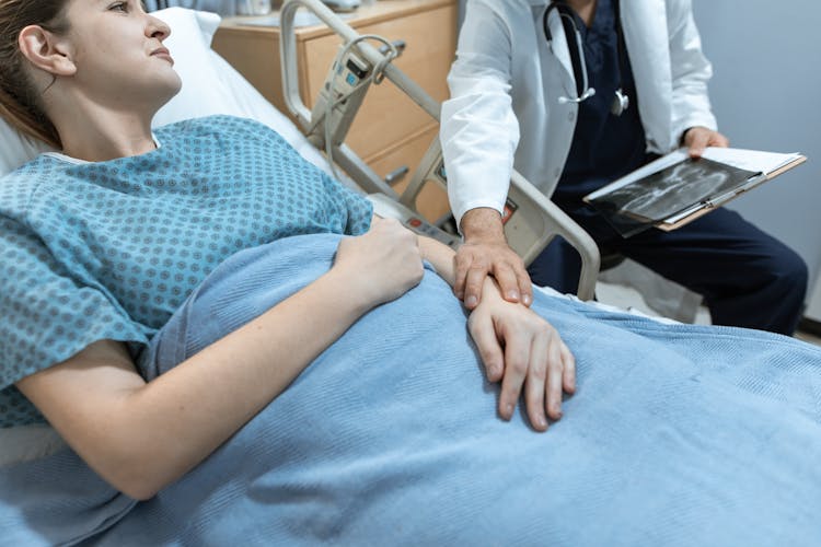 Doctor Touching The Arm Of A Patient