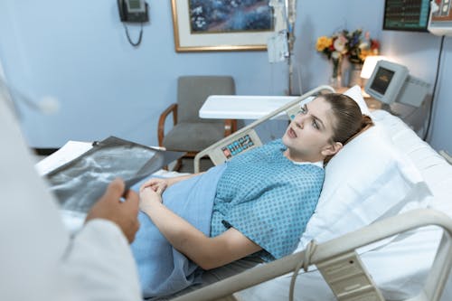 Free Patient Talking while Lying Down on a Hospital Bed Stock Photo