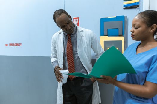 Photo by RDNE Stock project Doctors and nurse discussing medical charts in hospital setting.