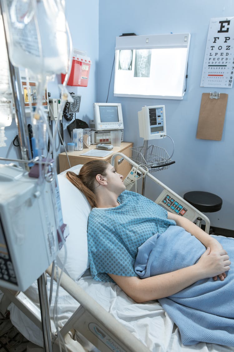 Sick Woman Lying On A Hospital Bed