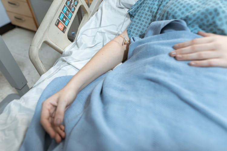 Blue Blanket On A Patient Lying On The Hospital Bed