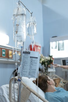 A patient receiving intravenous treatment in a hospital room, emphasizing healthcare and recovery.