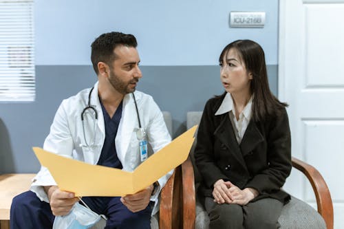 Free Male Doctor talking to a Patient  Stock Photo