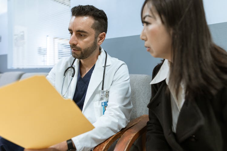 Male Doctor Talking To A Patient