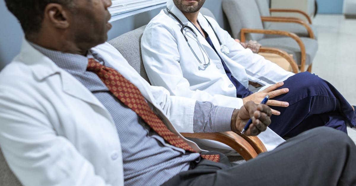 Photo by RDNE Stock project Two doctors sitting and discussing patient care in a hospital corridor.