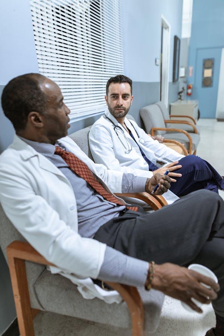 Two Male Doctors Talking With Each Other 