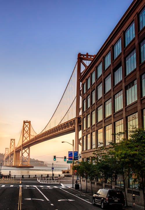 Free Brown Metal Bridge Near Building Stock Photo