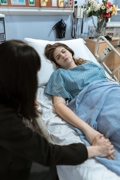 Free Patient Sleeping on a Hospital Bed Stock Photo