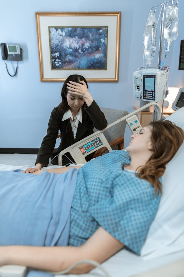 Worried Woman Beside A Female Patient 