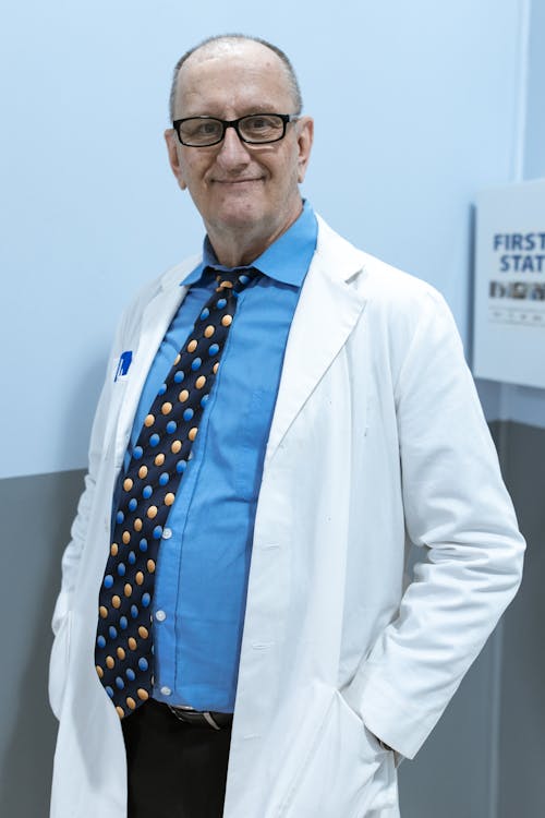 Free A Doctor Wearing a Lab Coat Smiling Stock Photo
