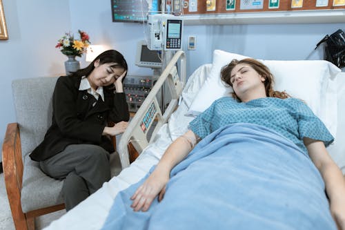 Free A Patient and Her Guardian Sleeping Stock Photo