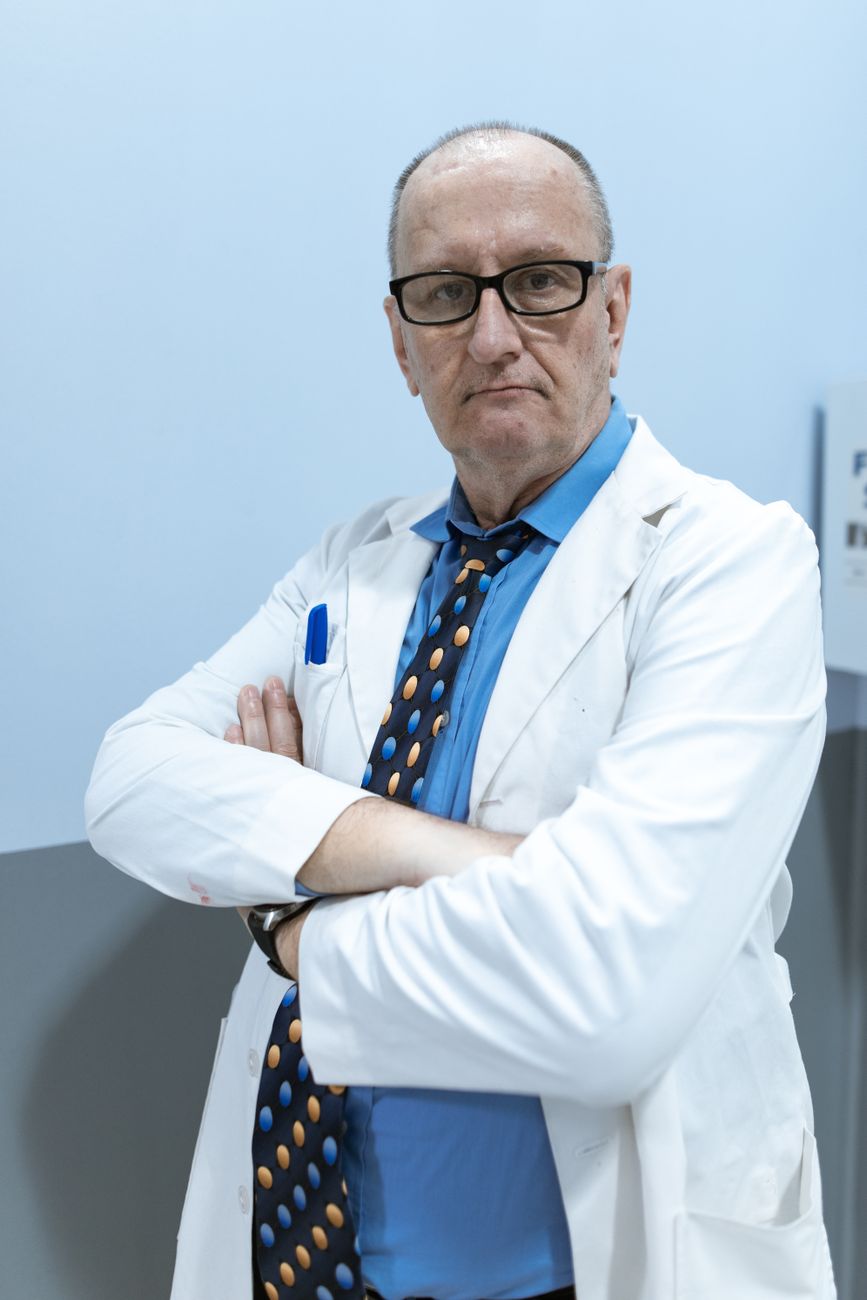 Dr. James Whitfield, body contouring expert, smiling in a white coat