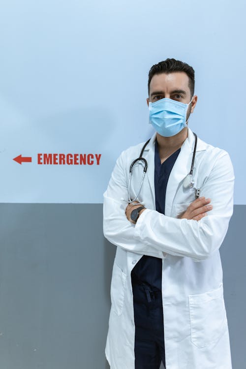Man in White Lab Coat Wearing Blue Face Mask