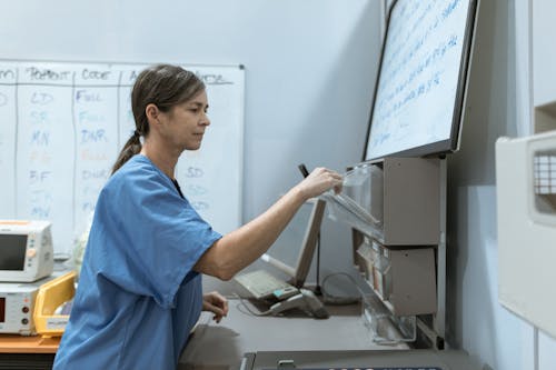 Free Medical Practitioner getting Medicine from Shelf Stock Photo