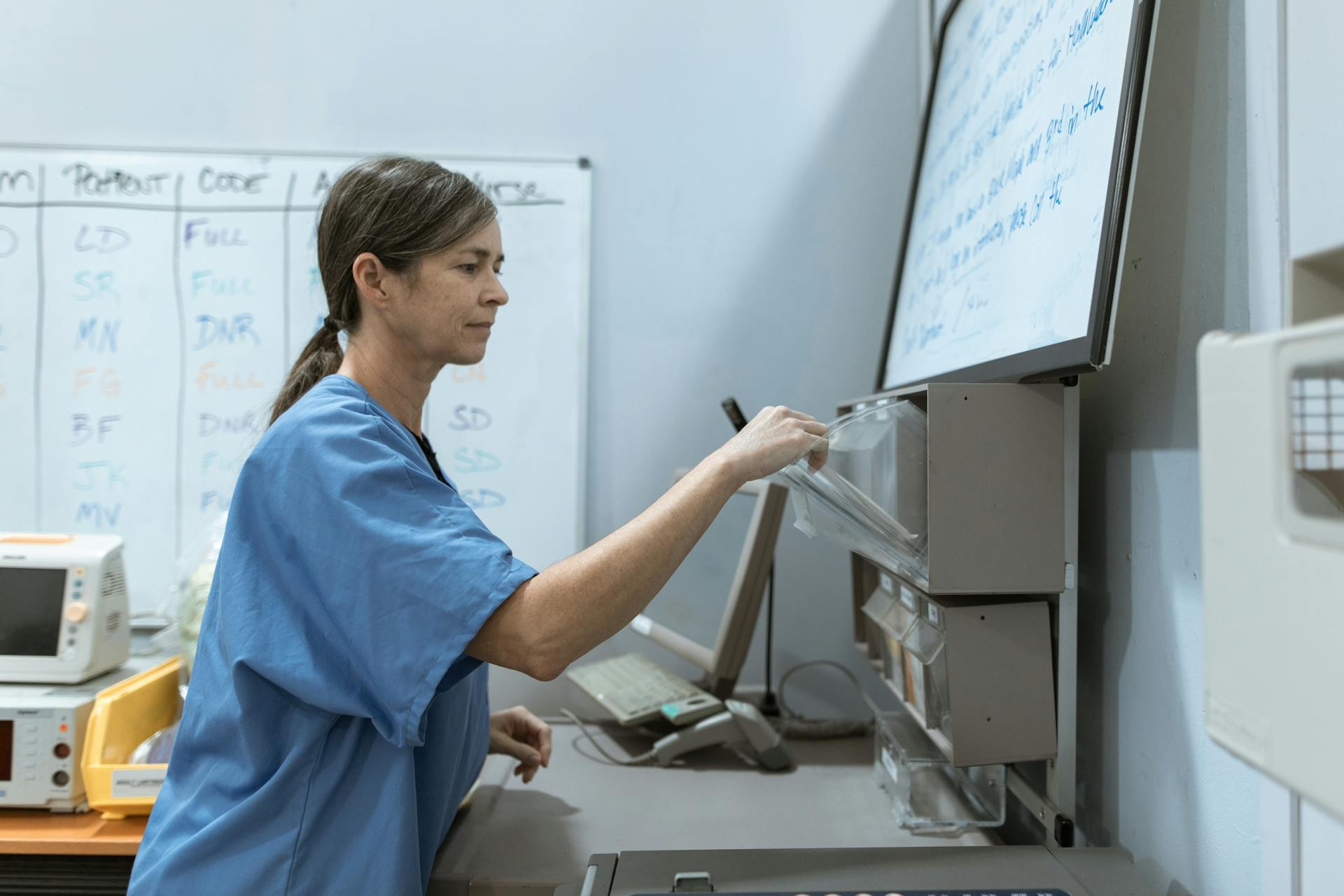 Nurse arranging medical supplies in a healthcare setting, highlighting organization and care.