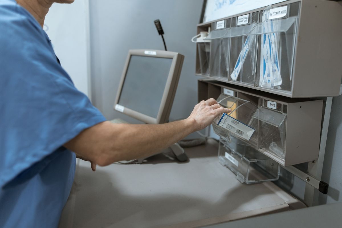 Pharmacy worker in blue scrubs