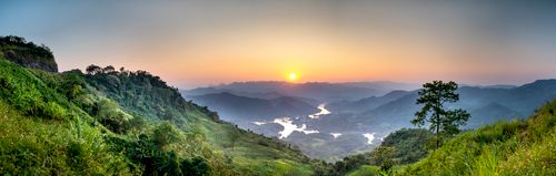 Free Breathtaking landscape of green hills with trees and bushes near river on background and grass in summer at sundown Stock Photo