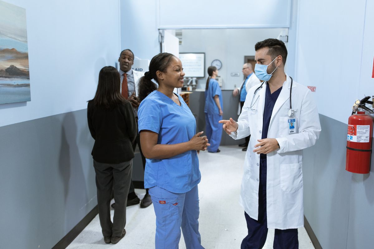 Doctors and nurses discussing in a hospital hallway