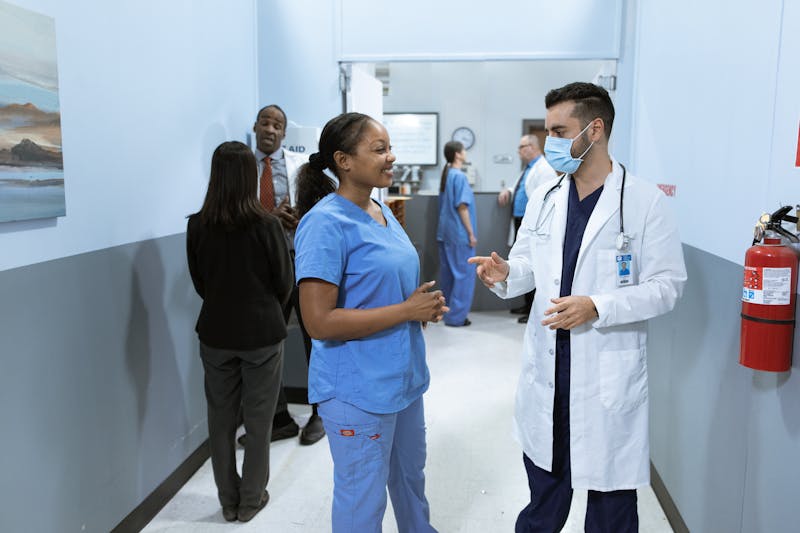 Compassionate healthcare professionals having a discussion in a modern medical office, depicting collaborative patient care and clinical communication