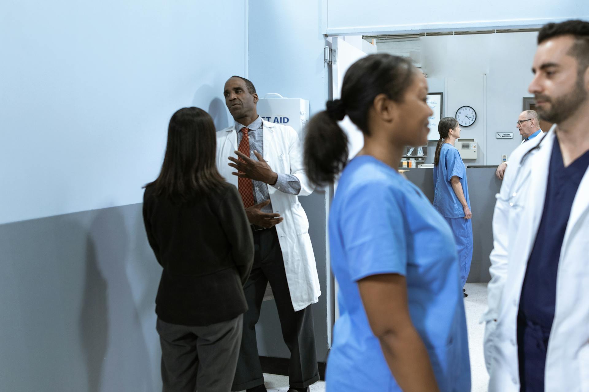 Doctors and nurses in discussion, showcasing teamwork in a hospital setting.