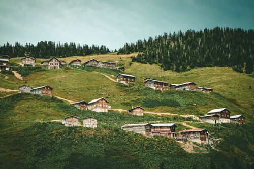 Free A picturesque view of traditional wooden houses spread across the lush hills of Rize, Turkey. Stock Photo