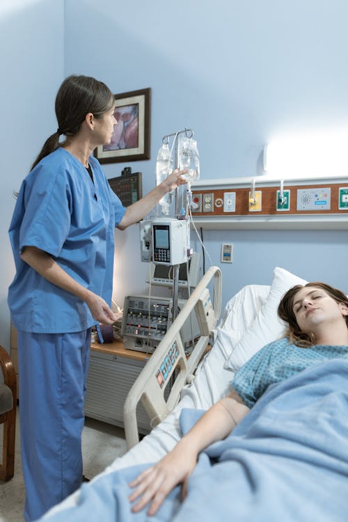 Free Nurse checking the Dextrose of a Patient  Stock Photo