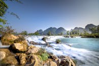Picturesque view of pond with waterfall near coast in highland