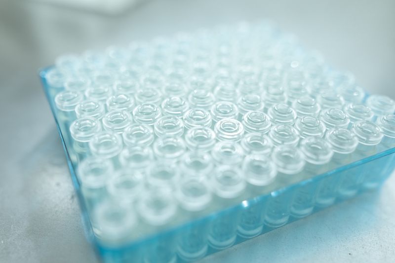 Transparent vials racked in a blue tray — photo by RDNE Stock project on Pexels