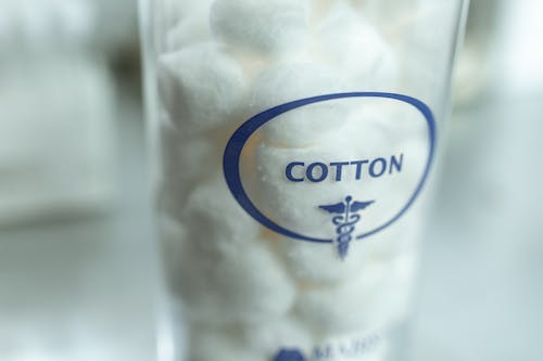Close-up Photo of Cotton Balls in a Glass Container