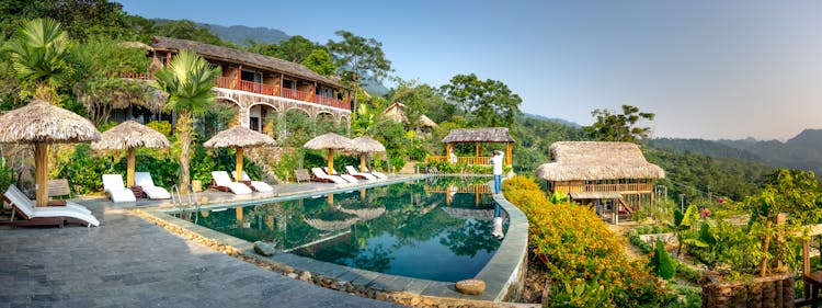 Swimming Pool And Small Hotel On Top Of Hill