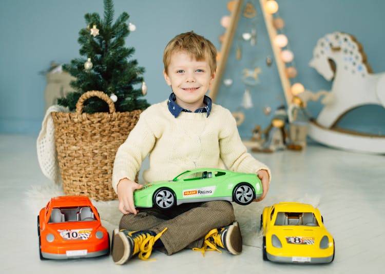 A Boy Holding Toy Car