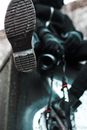From below of unrecognizable photographer in outerwear with professional photo camera sitting on black structure on street on blurred background