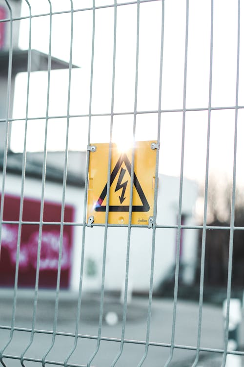 Free Sign of high voltage on fence Stock Photo