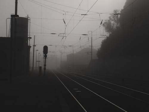 Grayscale Photo of Train Rail