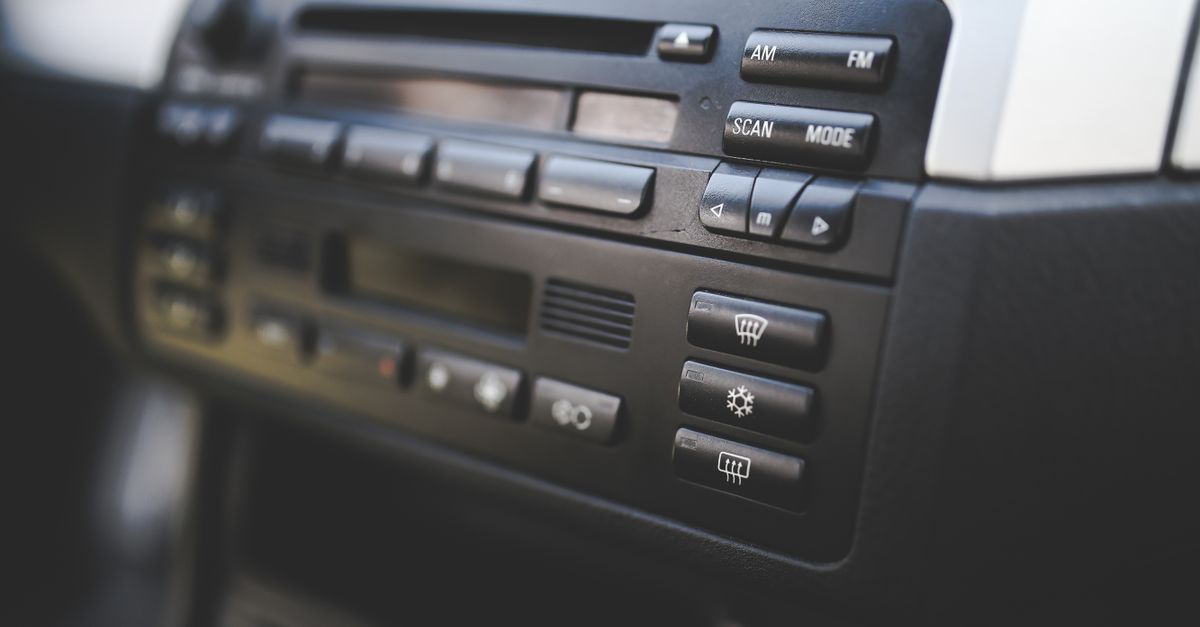 Detailed view of a car's radio and climate control panel, focusing on buttons.
