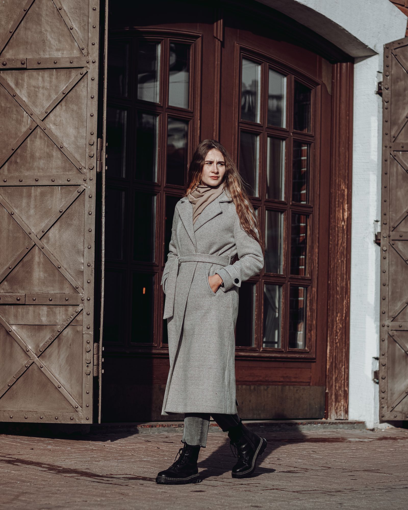Long charcoal wool coat with medium-wash jeans