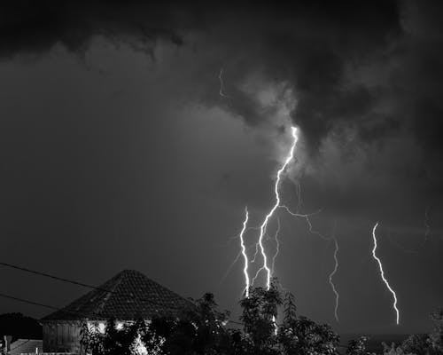Grayscale Photo of a Lightning on a Cloudy Sky