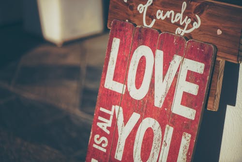 Free Love Text-printed Board Leaning on Wall Stock Photo