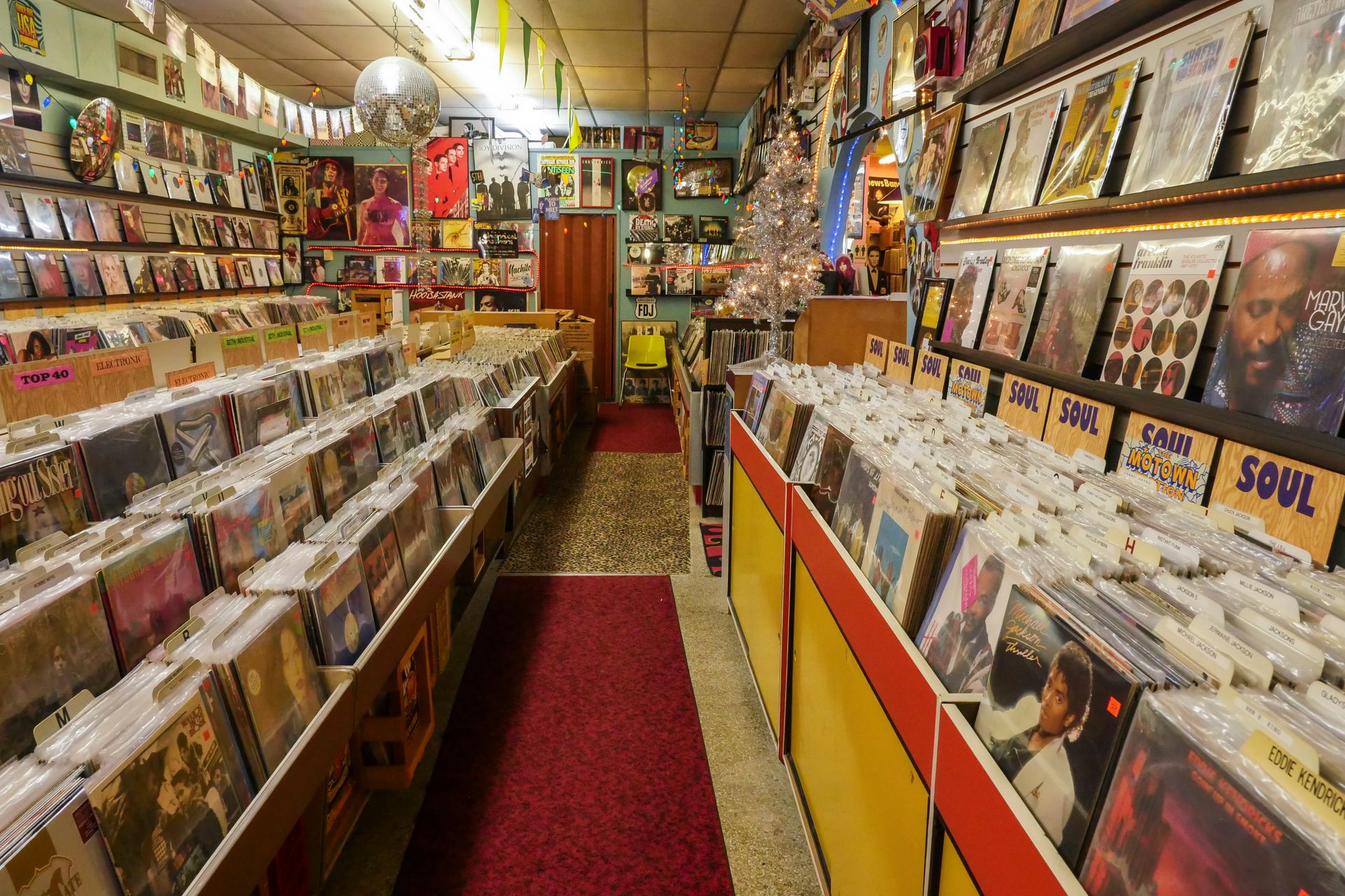 Cozy and colorful vinyl record store with rows of classic records and vibrant decor.