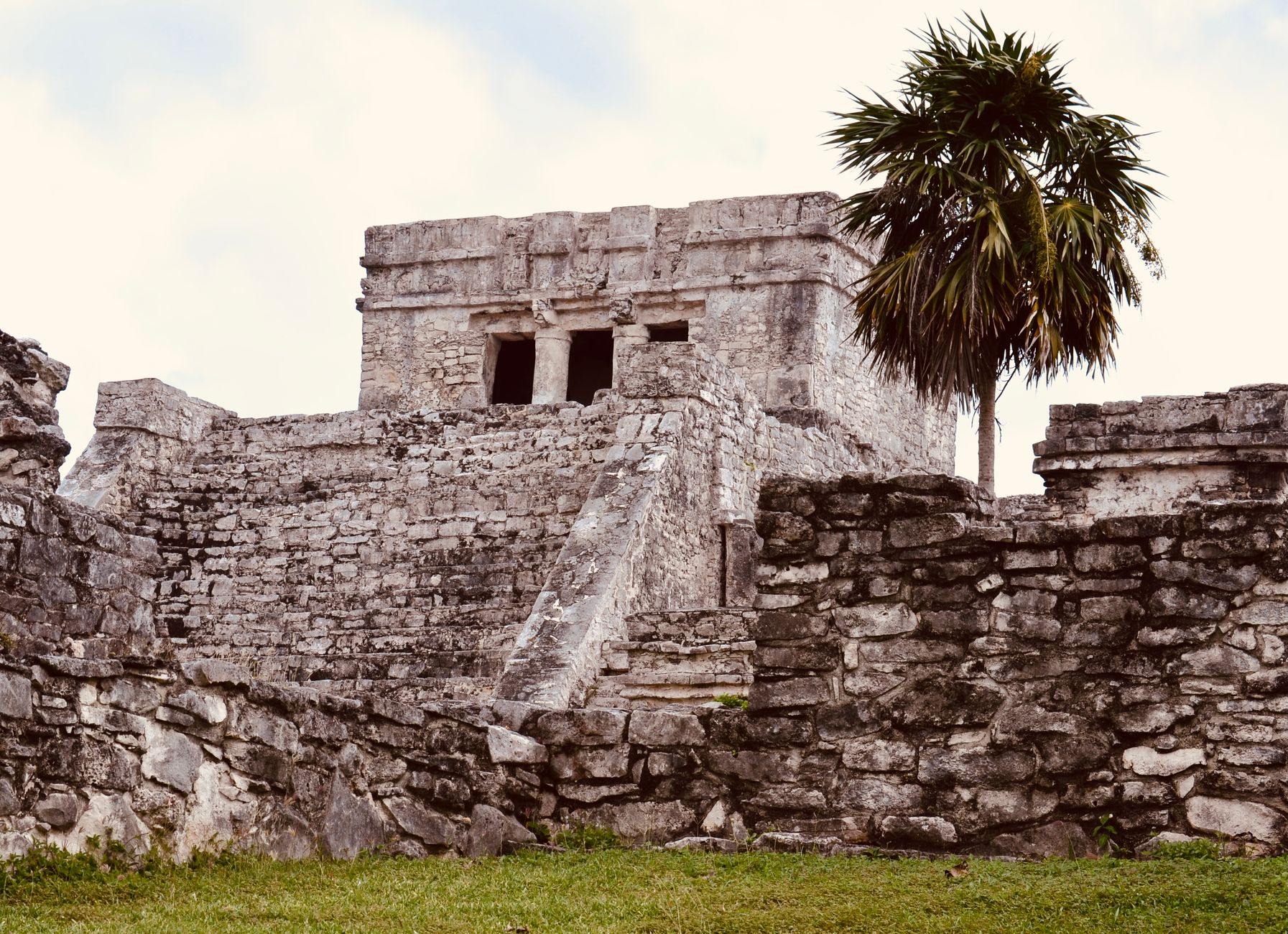 Explore the fascinating ruins of an ancient Mesoamerican civilization under a clear sky.