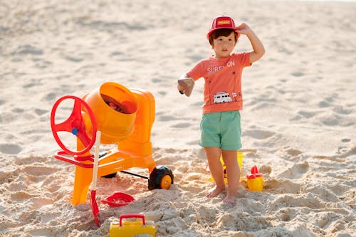 A Boy Playing Toys in Sand