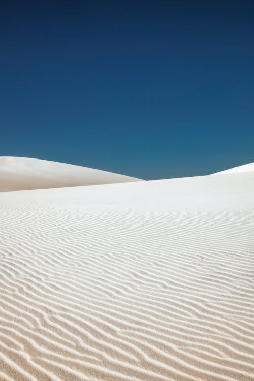 A White Sand Dunes Under Blue Sky