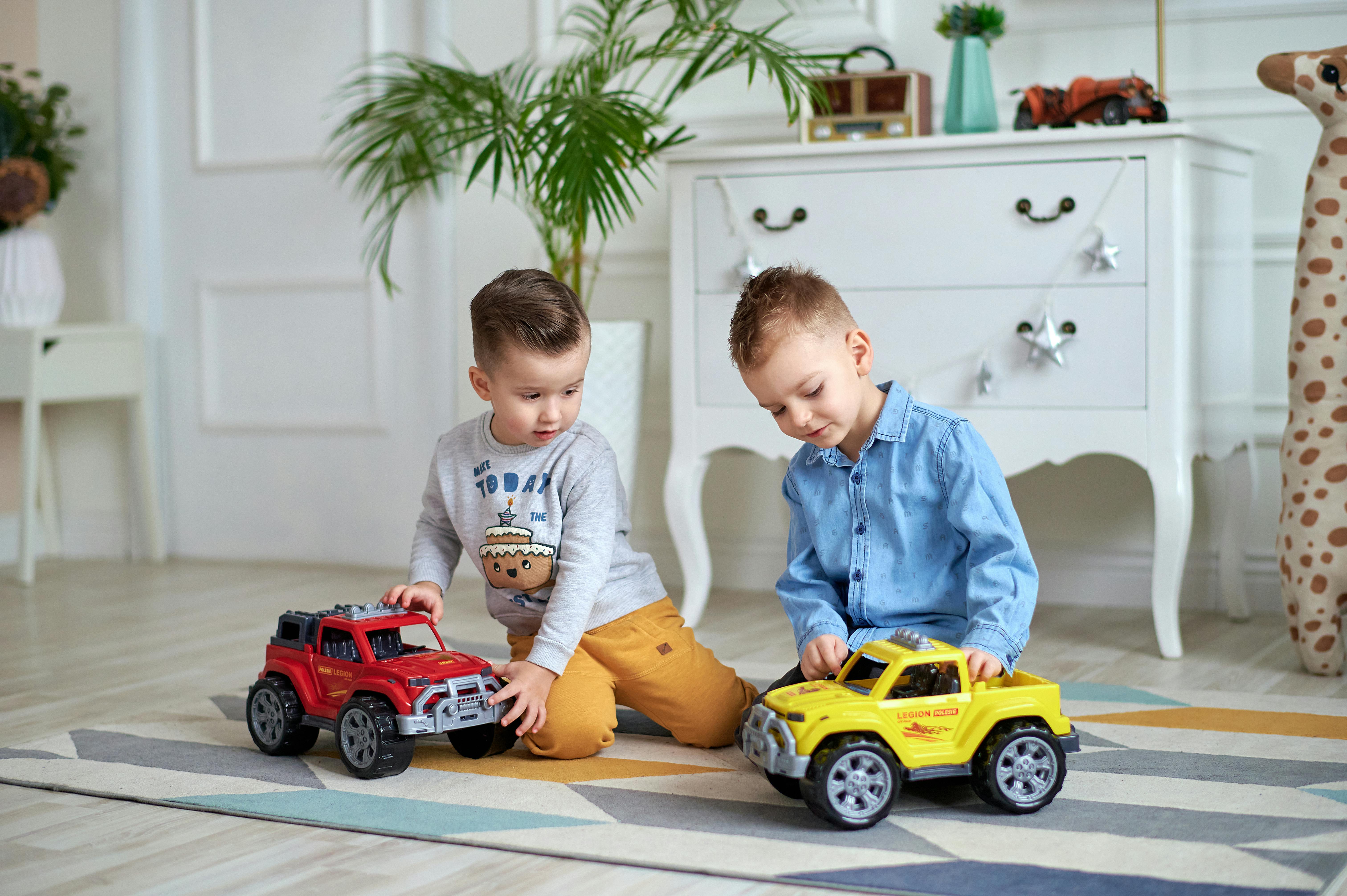 Two Boys Playing Toy Cars Free Stock Photo