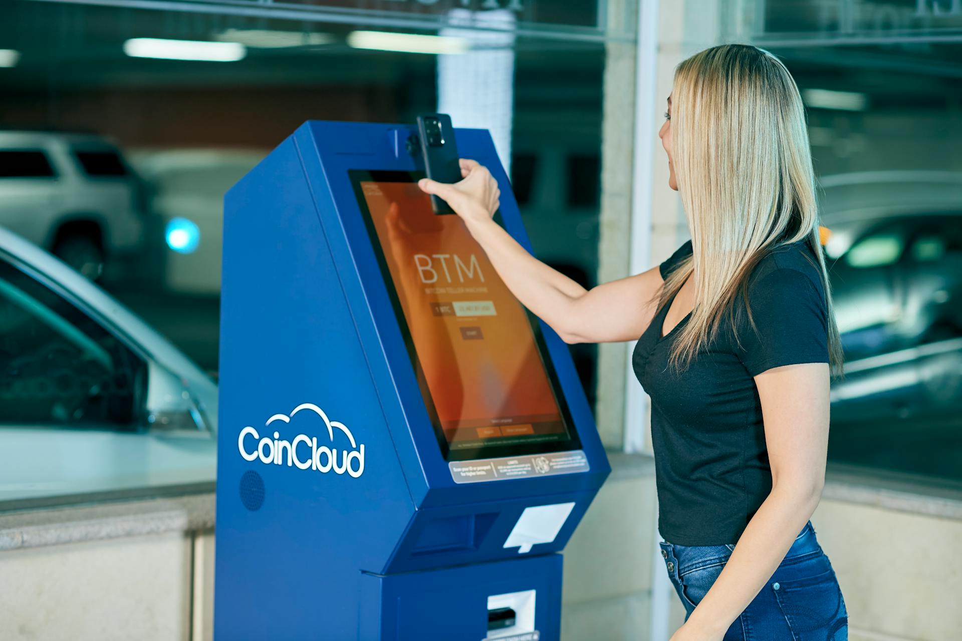 Woman Placing her Phone on a Machine