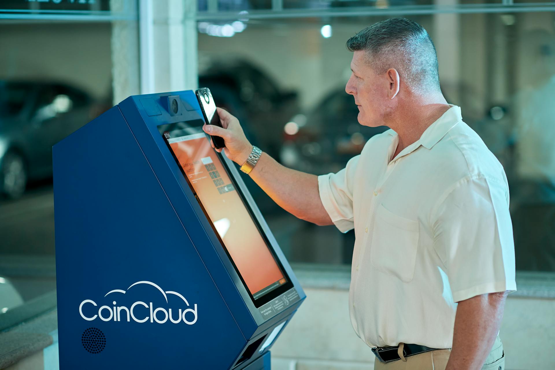 Man Using a Modern Touch Screen ATM