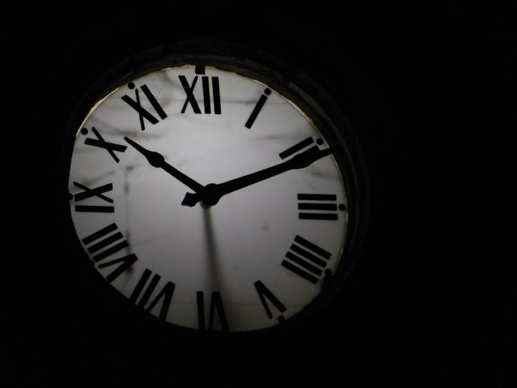 Round Mechanical Clock On Black Background