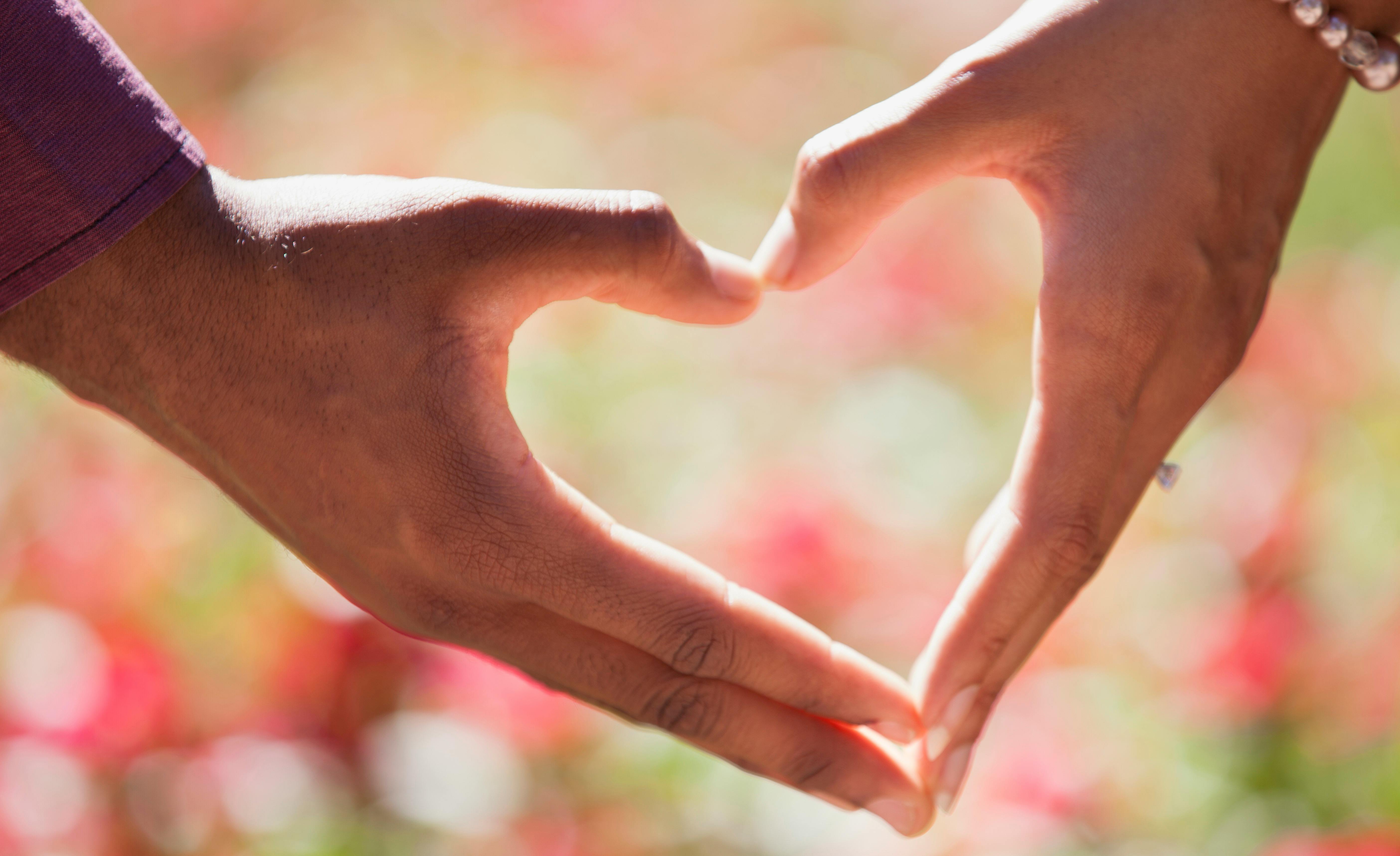 heart hand on shallow focus lens