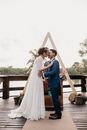 Diverse newlywed couple kissing on wedding day