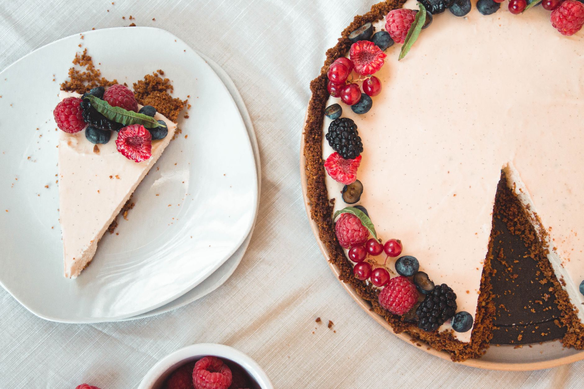 Delicious vegan tofu cheesecake served with fresh berries and lemon zest
