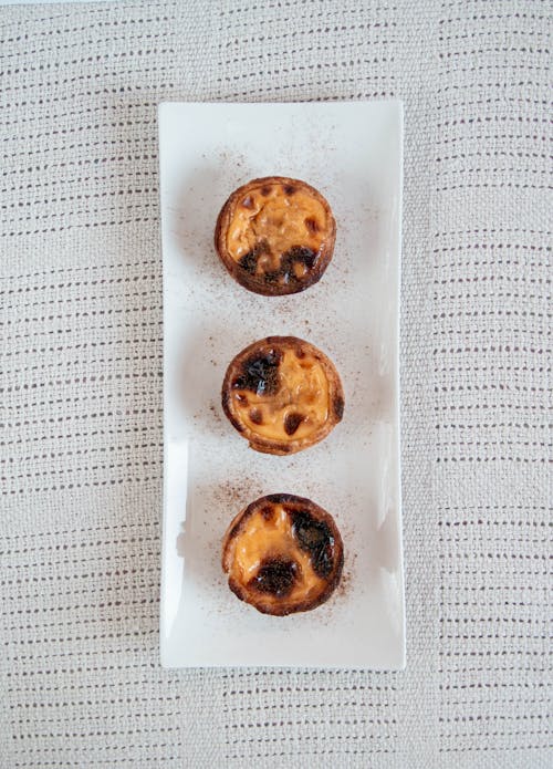 Three Egg Tarts on a Rectangular White Tray